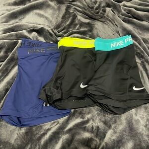 Three pairs of Nike spandex, all size medium.